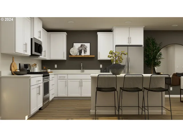 a kitchen with a table chairs a microwave and cabinets