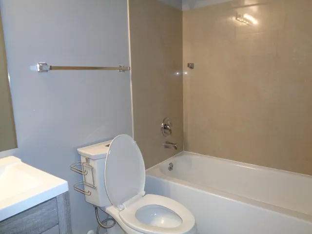 a bathroom with a toilet and bathtub