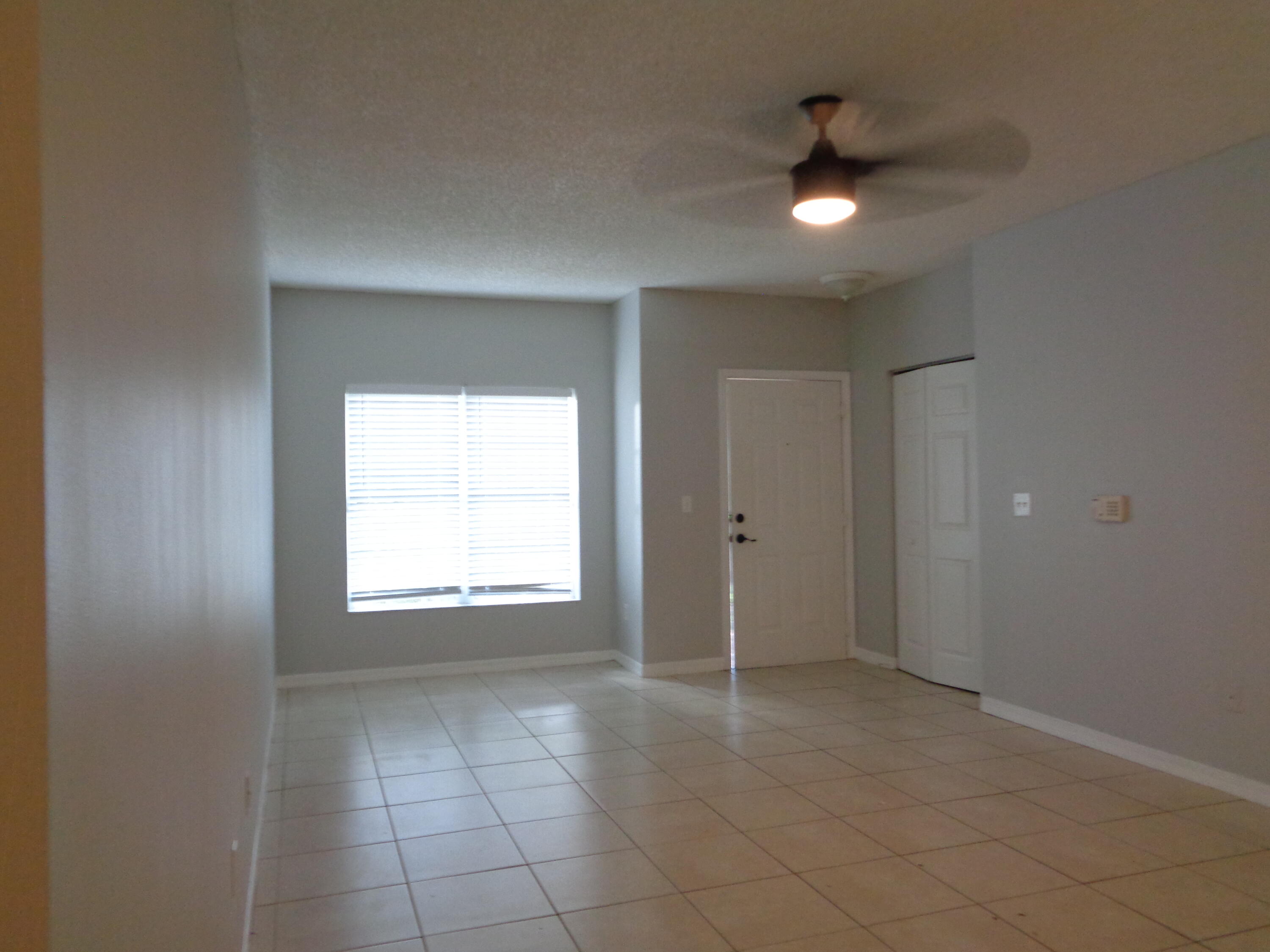 10354 Fox Trail Road South, Unit 1509 Royal Palm Beach, FL 33411 - Photo 5 of 13 a view of an empty room with a window