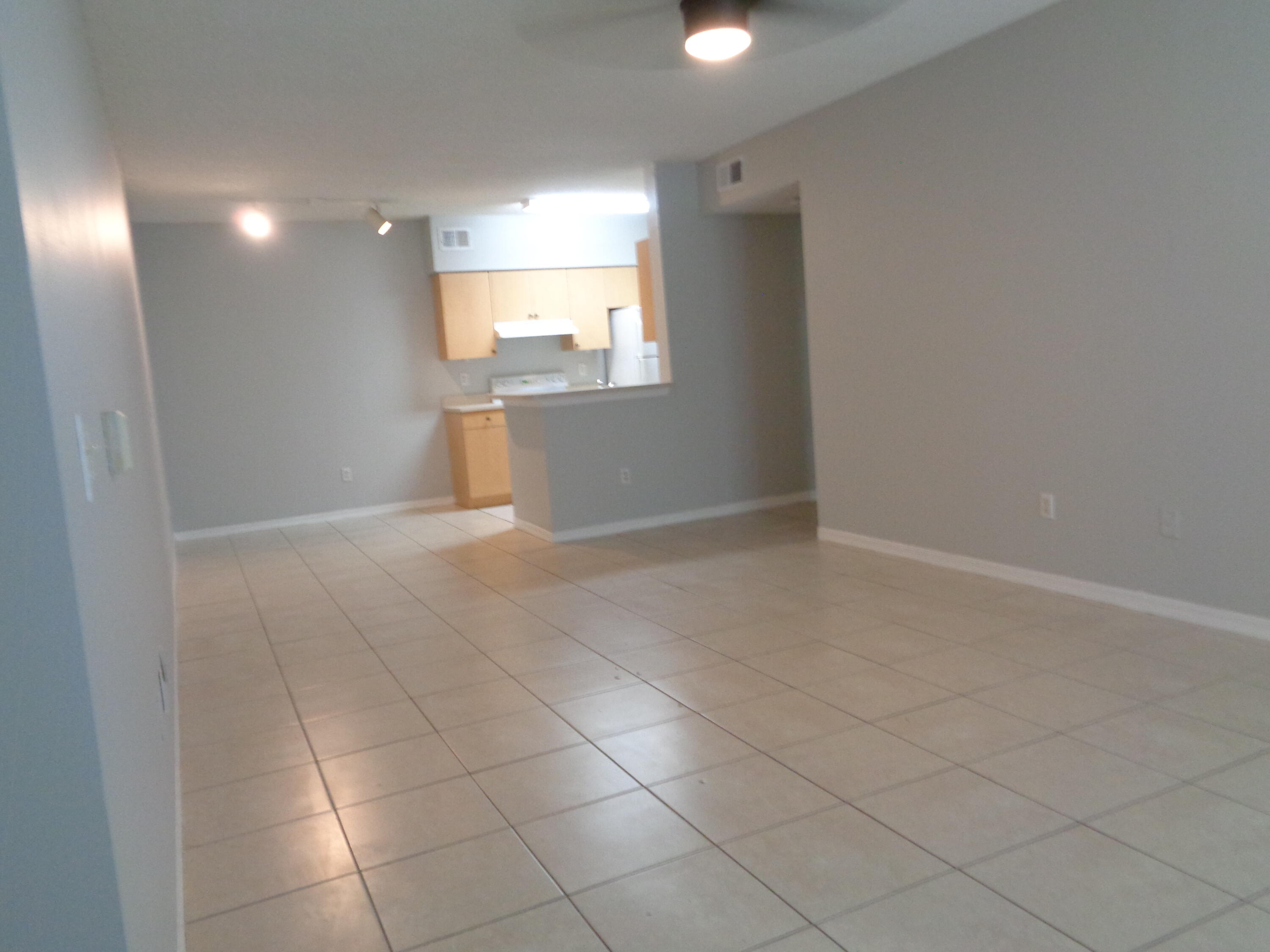 10354 Fox Trail Road South, Unit 1509 Royal Palm Beach, FL 33411 - Photo 6 of 13 an empty room with a empty space and windows