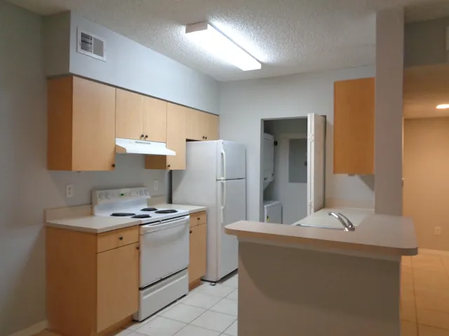 a kitchen that has a sink and a stove in it