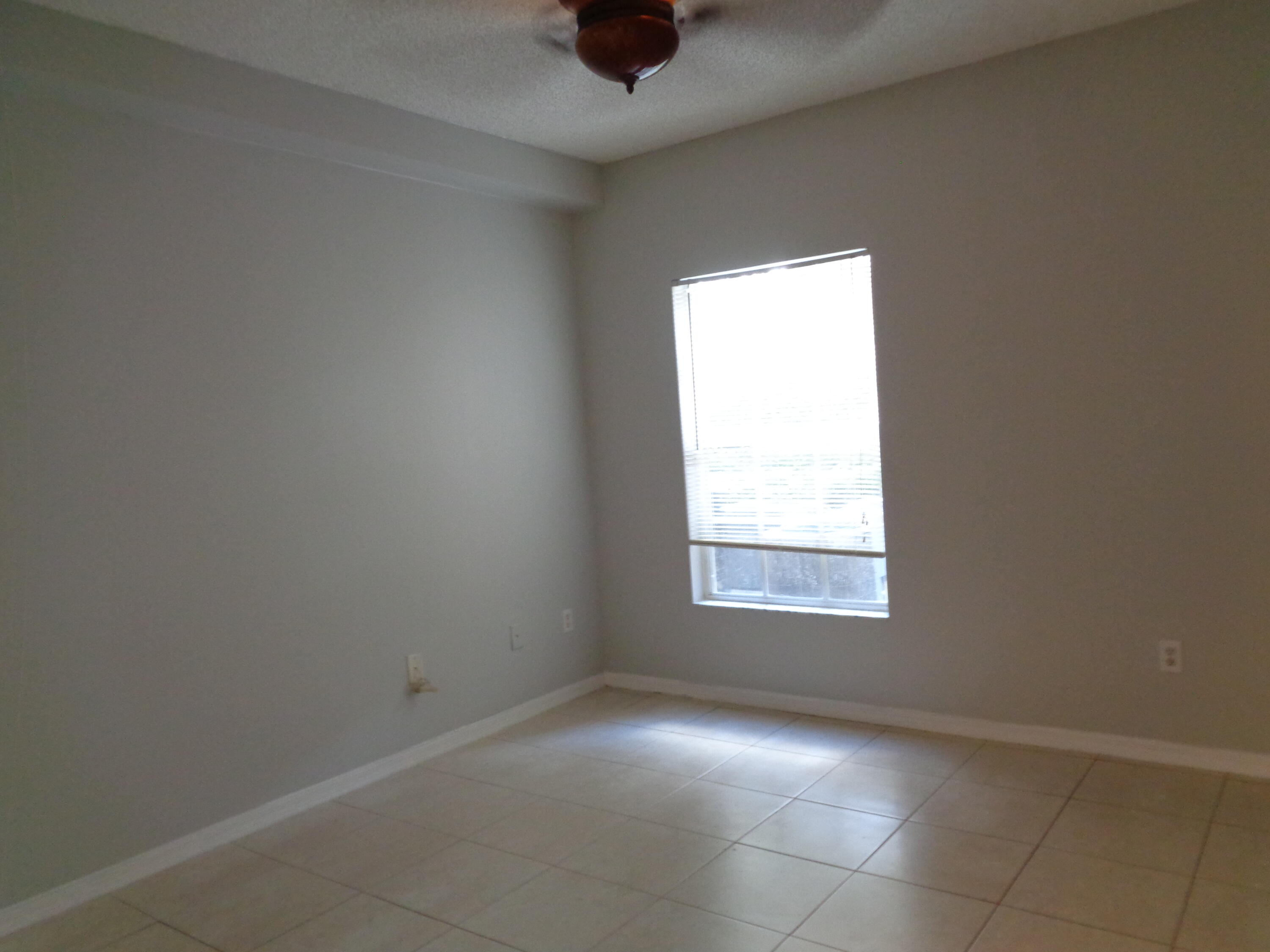10354 Fox Trail Road South, Unit 1509 Royal Palm Beach, FL 33411 - Photo 8 of 13 an empty room with a window