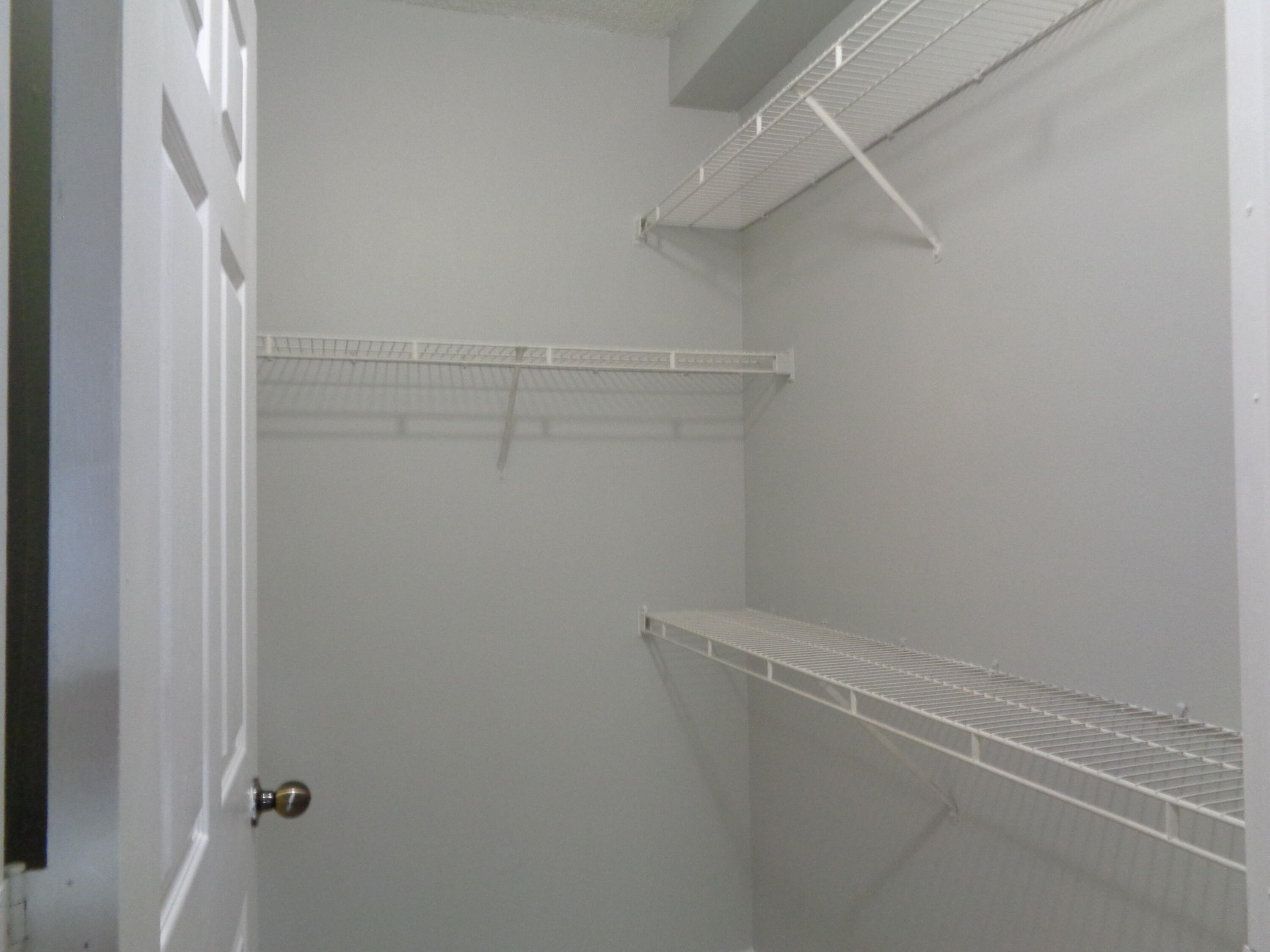 10354 Fox Trail Road South, Unit 1509 Royal Palm Beach, FL 33411 - Photo 9 of 13 a view of a room with racks on the wall