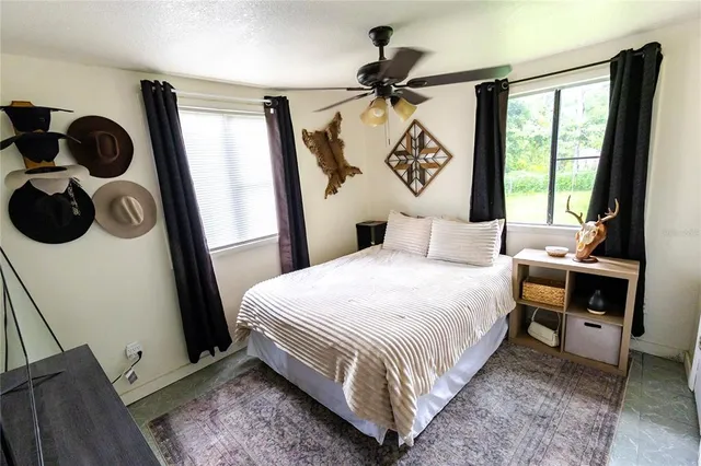 a bedroom with a large bed and a window