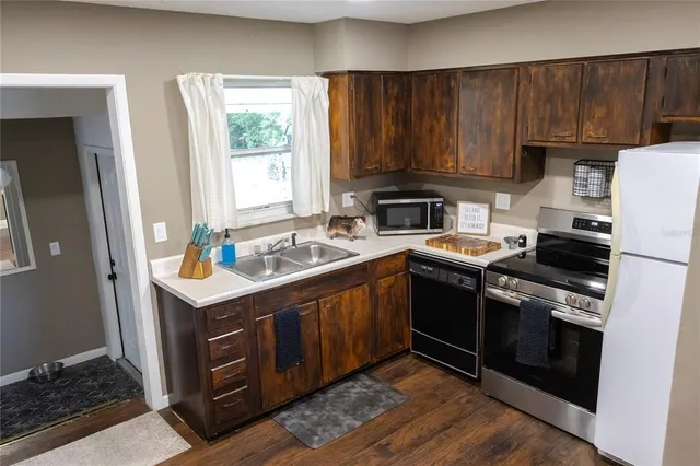 a kitchen with a sink stove and cabinets