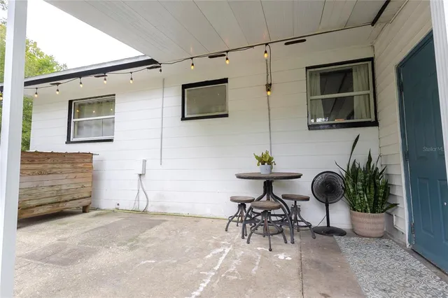 a house with potted plants in front of it