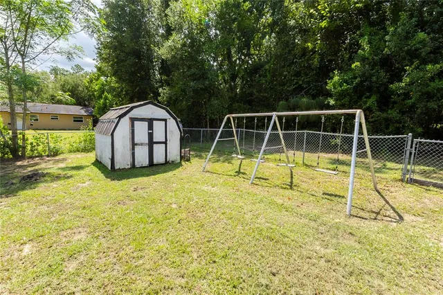 a view of a backyard with swimming pool