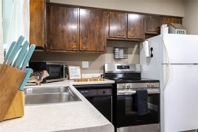 a kitchen with a sink a stove and cabinets