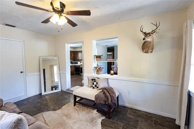 a spacious bedroom with a bed and a chandelier