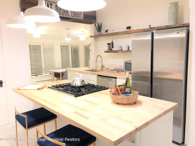 a kitchen with a sink appliances and cabinets