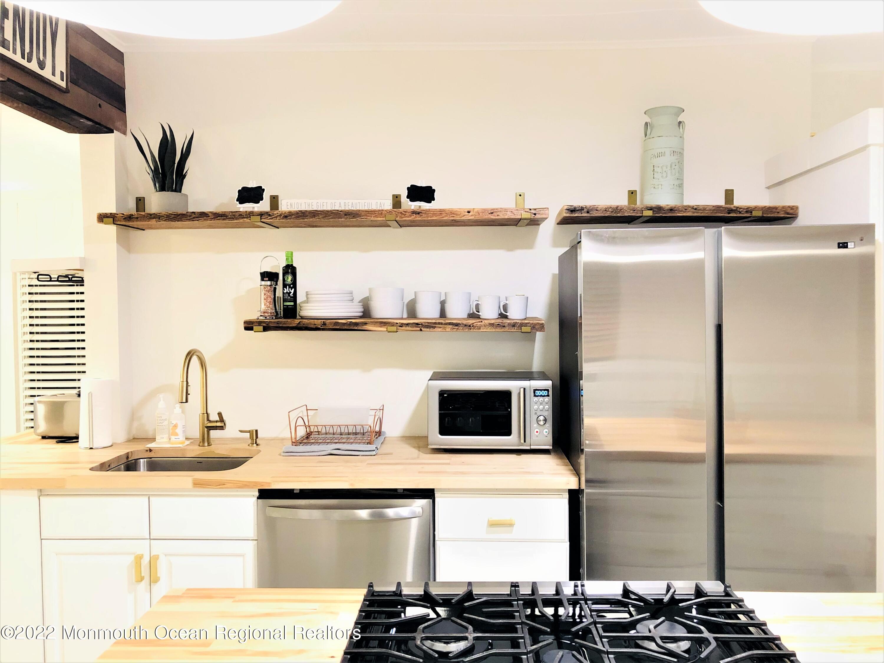 487 West Street Long Branch, NJ 07740 - Photo 12 of 48 a kitchen with a refrigerator and a sink