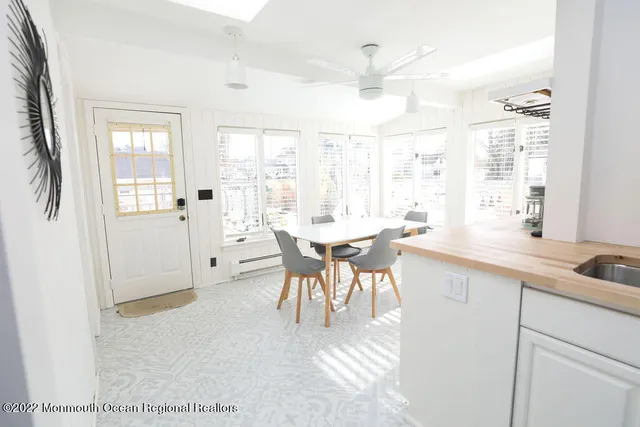 a open kitchen with a sink table and chairs