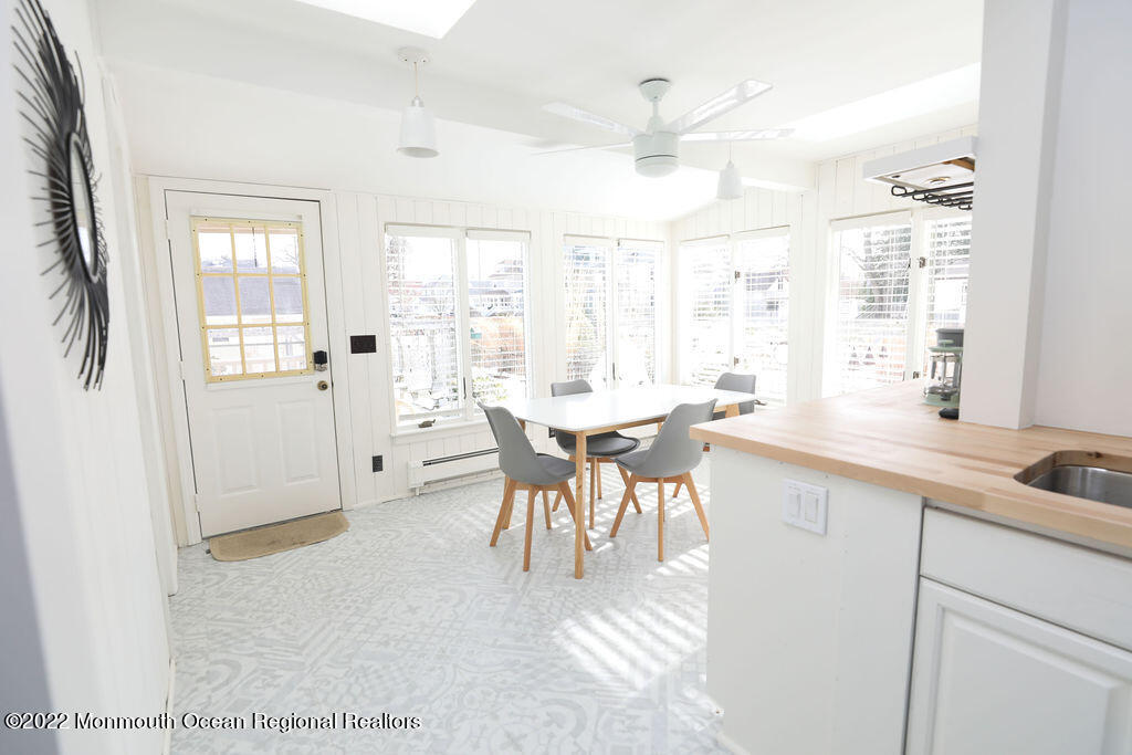 487 West Street Long Branch, NJ 07740 - Photo 13 of 48 a open kitchen with a sink table and chairs