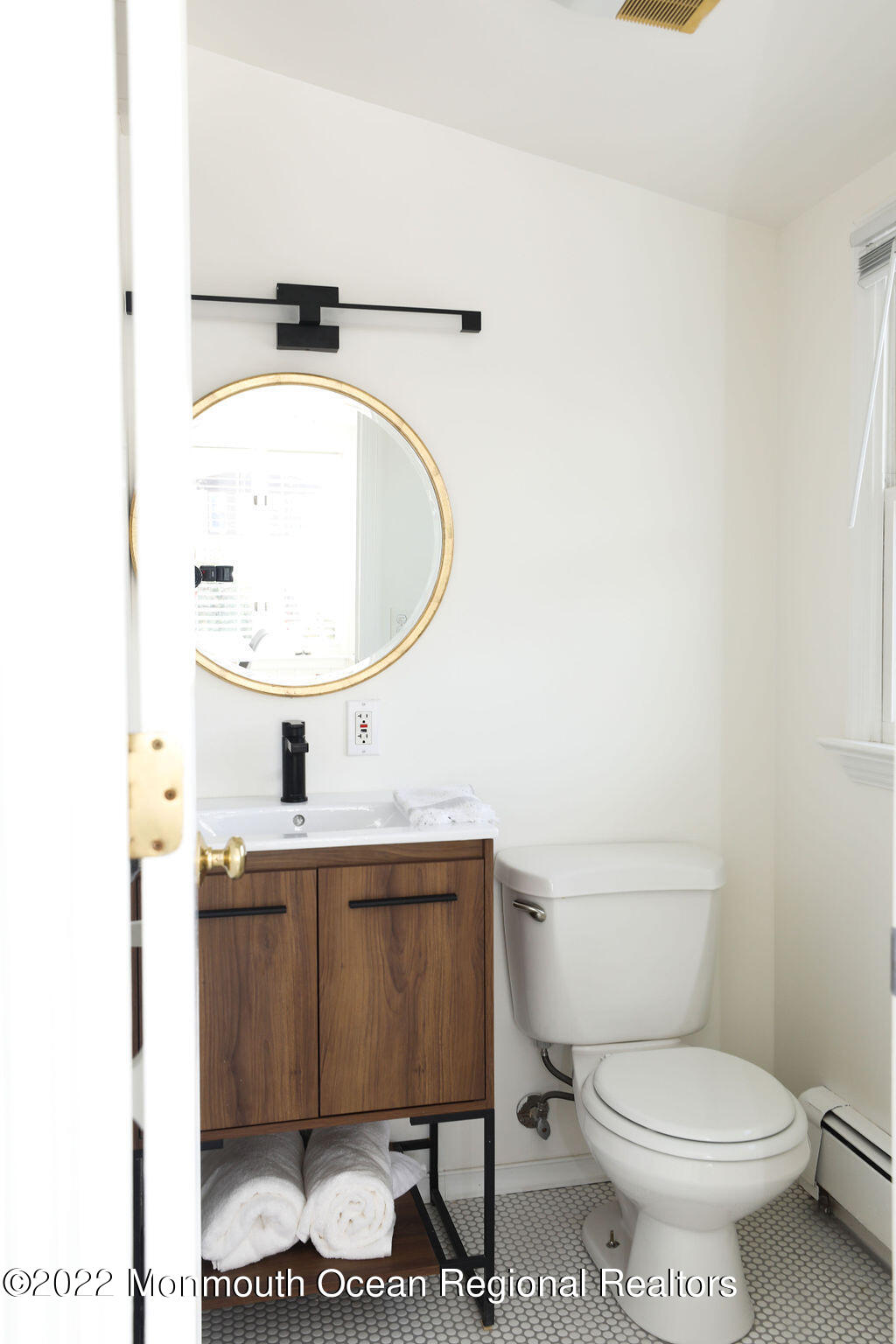 487 West Street Long Branch, NJ 07740 - Photo 16 of 48 a bathroom with a toilet a sink and a mirror