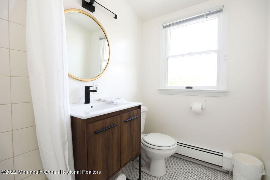 487 West Street Long Branch, NJ 07740 - Photo 17 of 48 a bathroom with a toilet sink and mirror