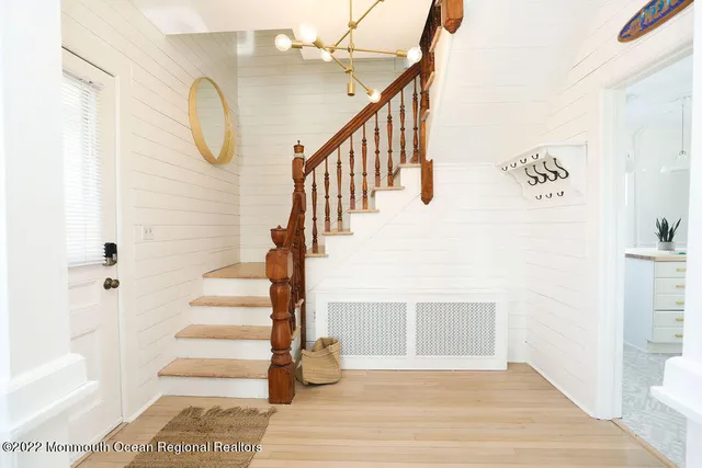 a view of entryway and hall with wooden floor