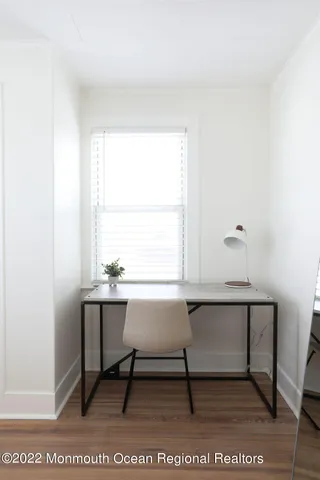 a workspace with a table chair and window