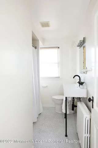 a bathroom with a sink a toilet and a tub