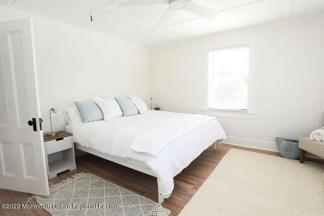 a large bed sitting in a bedroom next to a window
