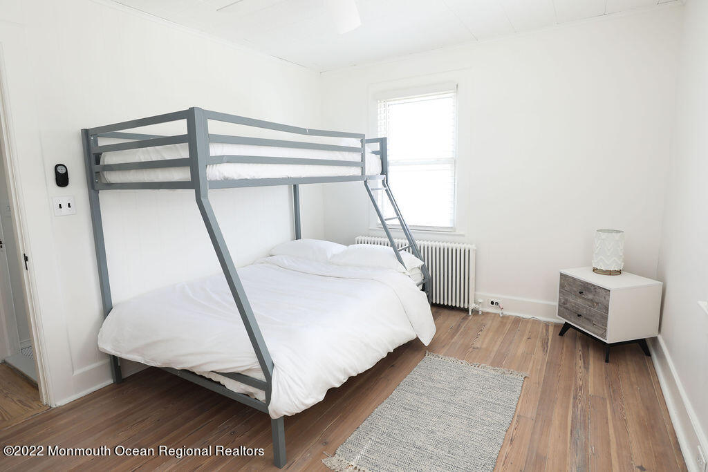 487 West Street Long Branch, NJ 07740 - Photo 28 of 48 a bedroom with a bed and wooden floor