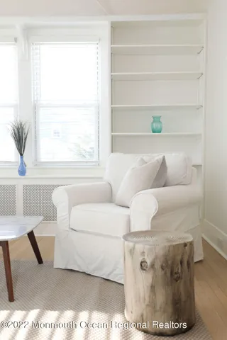 a living room with furniture a table and a large window