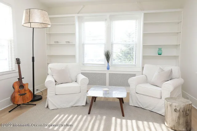 a view of a house with a small yard plants and large tree