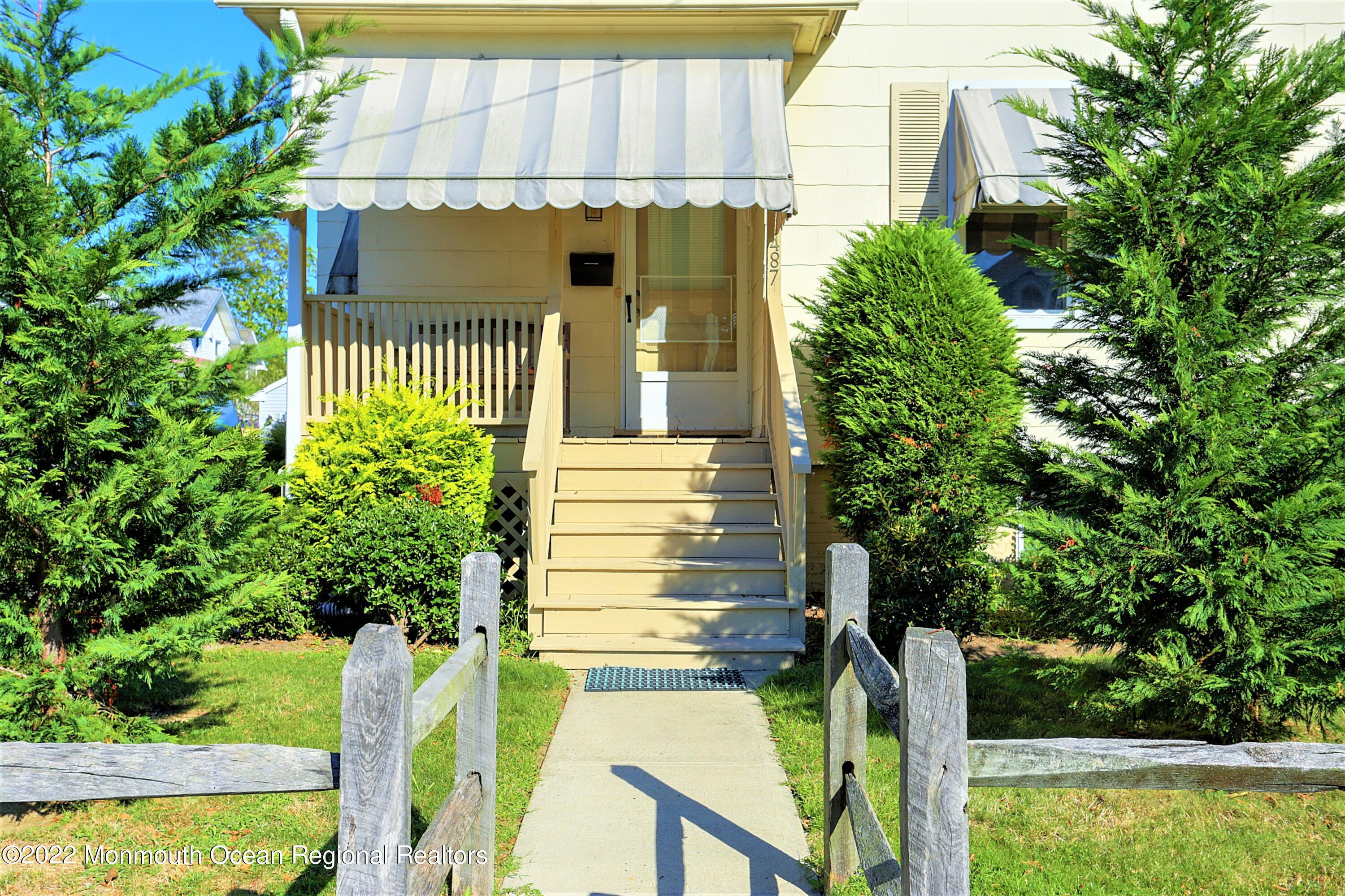 487 West Street Long Branch, NJ 07740 - Photo 42 of 48 a view of a house with a small yard plants and large tree