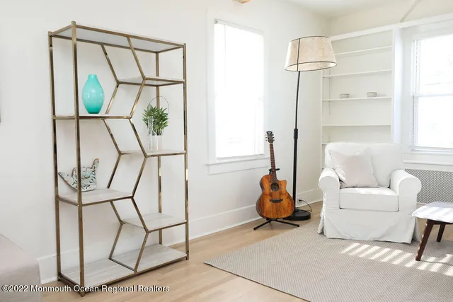 a living room with furniture a air conditioner and a window