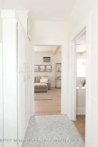 a view of a bedroom with a white bed and a dresser
