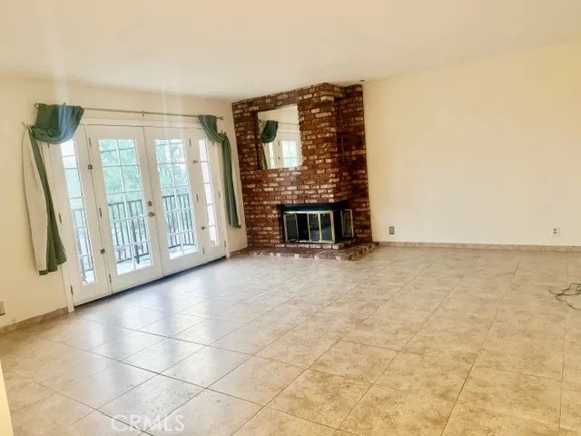 a view of an empty room with a fireplace