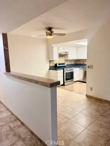 a kitchen with stainless steel appliances a stove top oven and cabinets