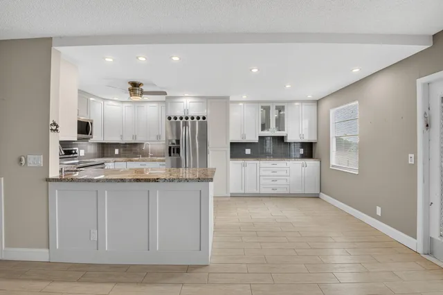 a view of a kitchen with electric appliances
