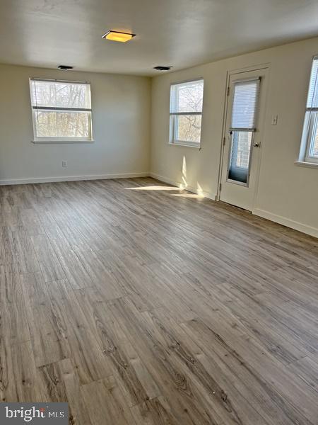 2135 Suburban Road, Unit 5 York, PA 17403 - Photo 2 of 7 an empty room with wooden floor and windows