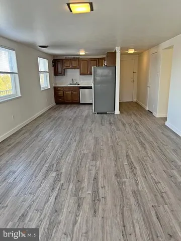 a view of a room with wooden floor and window