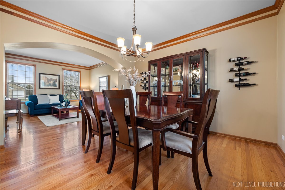 2620 Sweetbroom Road Naperville, IL 60564 - Photo 3 of 30 a view of a dining room with furniture and wooden floor