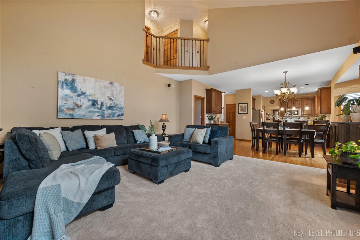 2620 Sweetbroom Road Naperville, IL 60564 - Photo 8 of 30 a living room with furniture and kitchen view