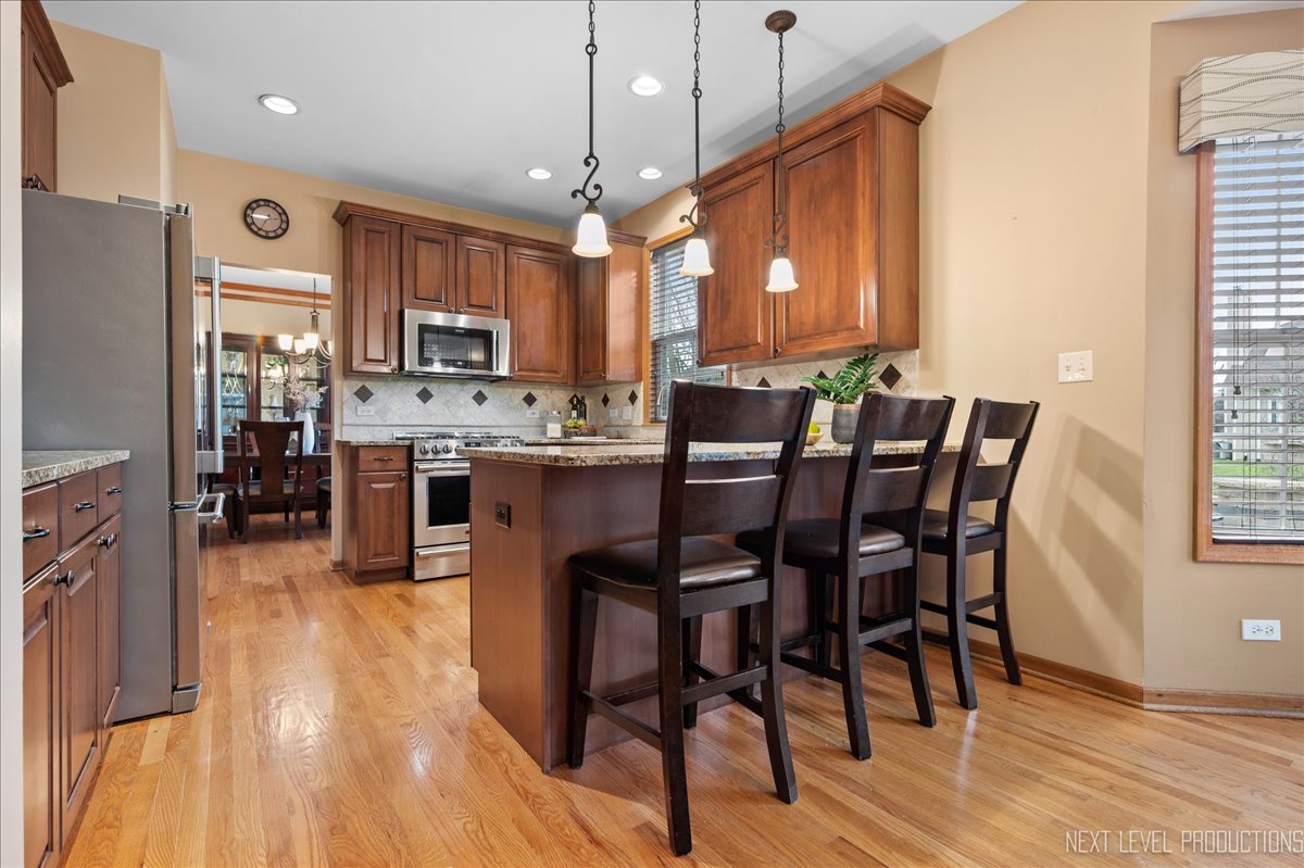 2620 Sweetbroom Road Naperville, IL 60564 - Photo 10 of 30 a view of a dining room with furniture window and wooden floor