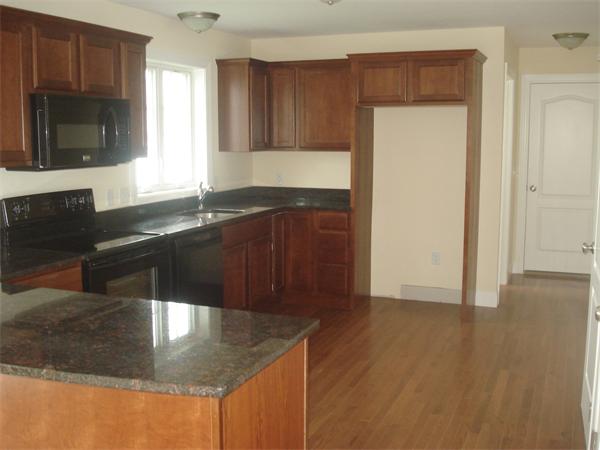 311 Arnold Springfield, MA 01119 - Photo 4 of 22 a kitchen with granite countertop a sink a stove and cabinets