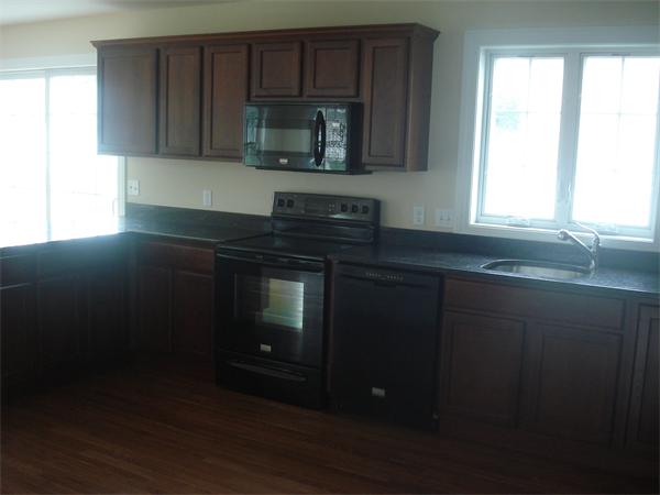 311 Arnold Springfield, MA 01119 - Photo 5 of 22 a kitchen with granite countertop wood cabinets and a stove top oven