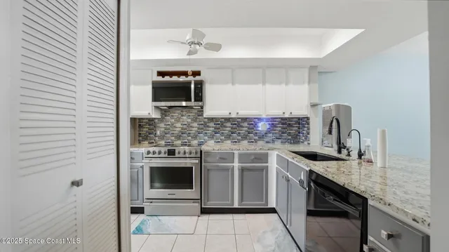 a kitchen with stainless steel appliances granite countertop a sink stove and cabinets