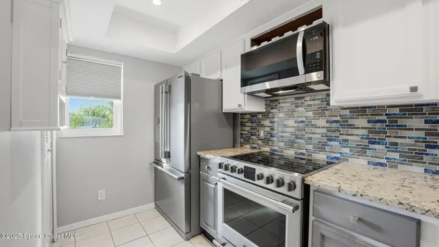 a kitchen with cabinets and a stove top oven