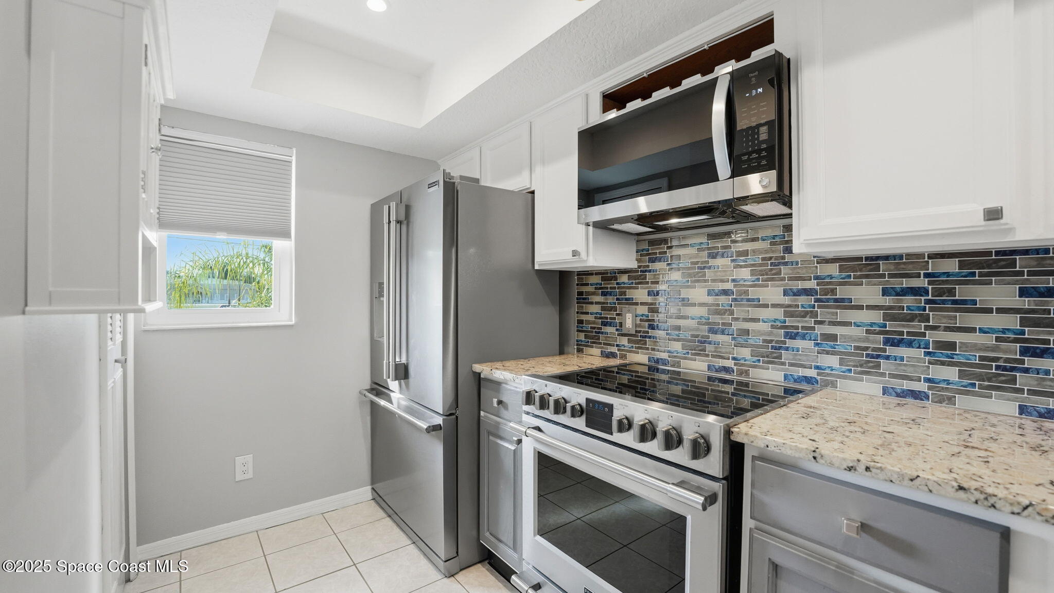 5087 Riveredge Drive, Unit 2 Titusville, FL 32780 - Photo 15 of 62 a kitchen with a stove and a refrigerator
