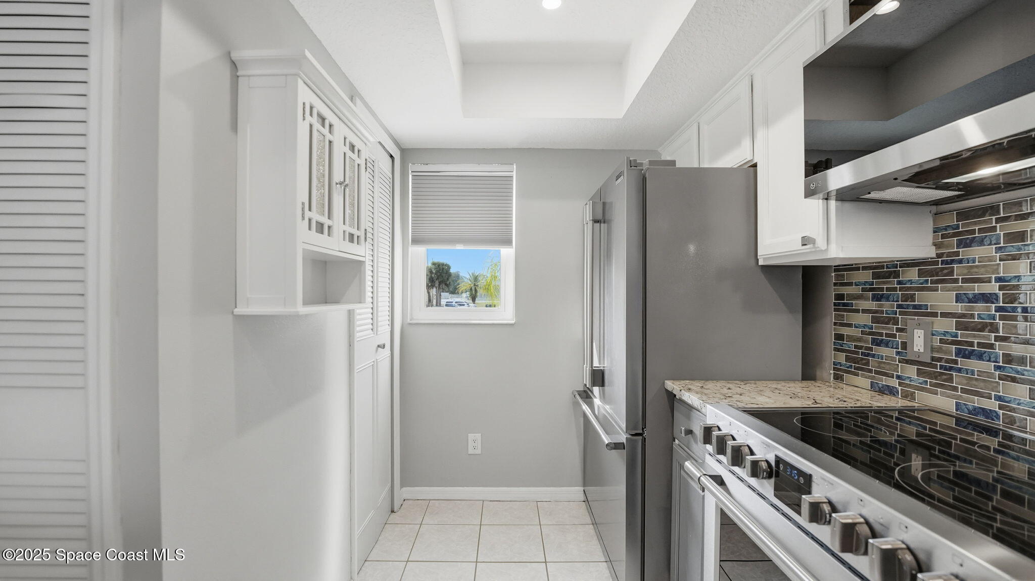 5087 Riveredge Drive, Unit 2 Titusville, FL 32780 - Photo 16 of 62 a kitchen with cabinets and a stove top oven
