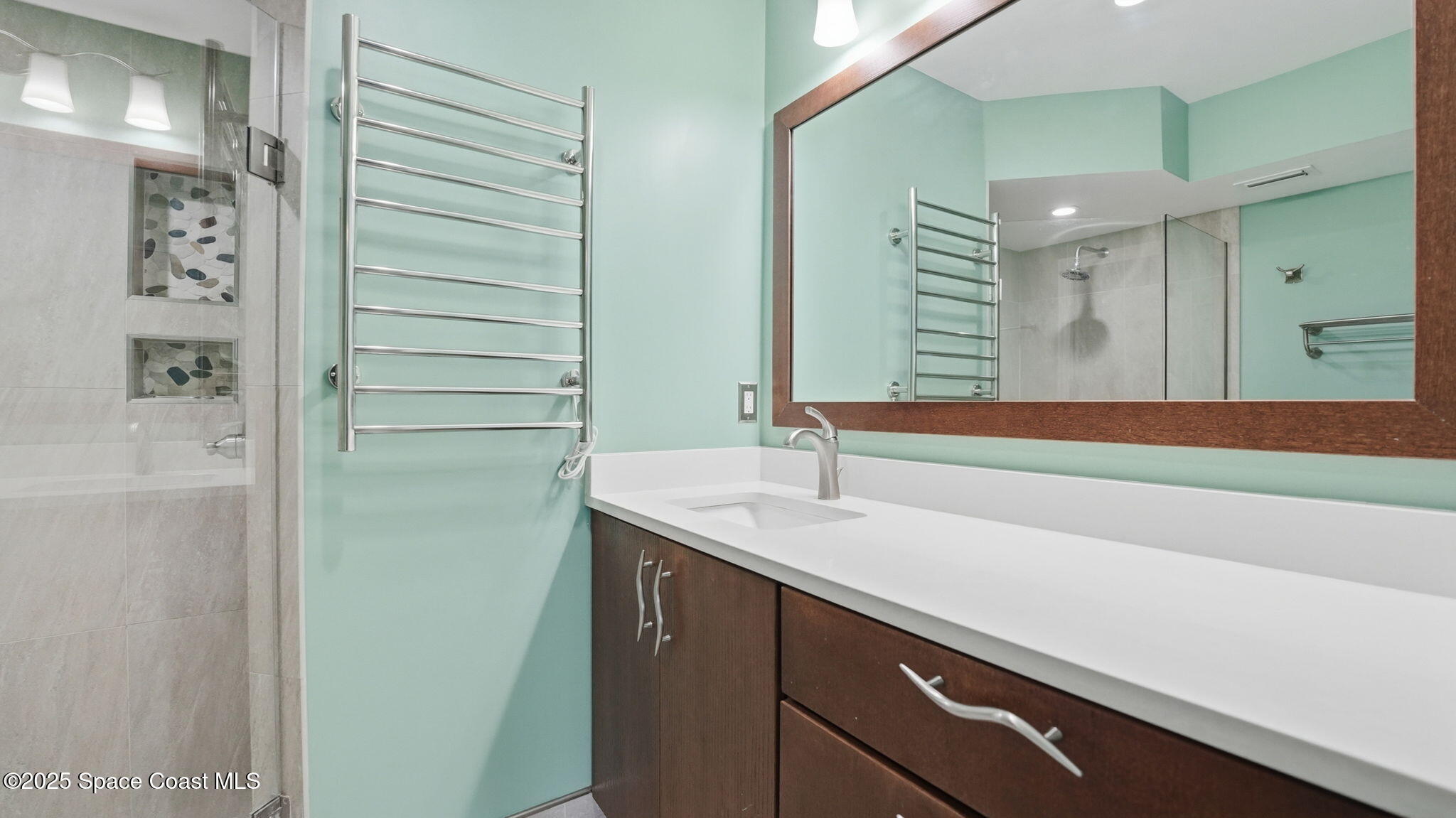 5087 Riveredge Drive, Unit 2 Titusville, FL 32780 - Photo 19 of 62 a bathroom with a sink and a mirror