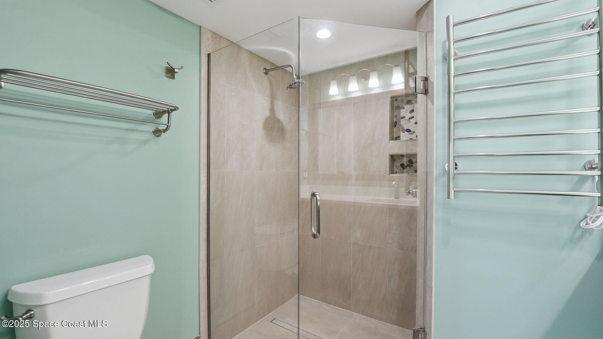 5087 Riveredge Drive, Unit 2 Titusville, FL 32780 - Photo 20 of 62 a bathroom with a shower a toilet and a sink