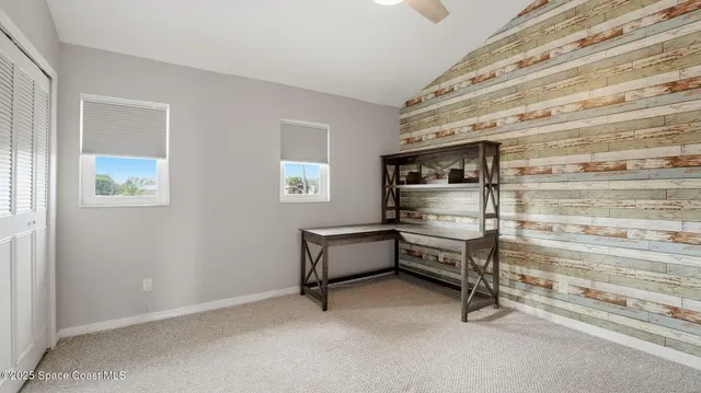 a view of room with window and furniture