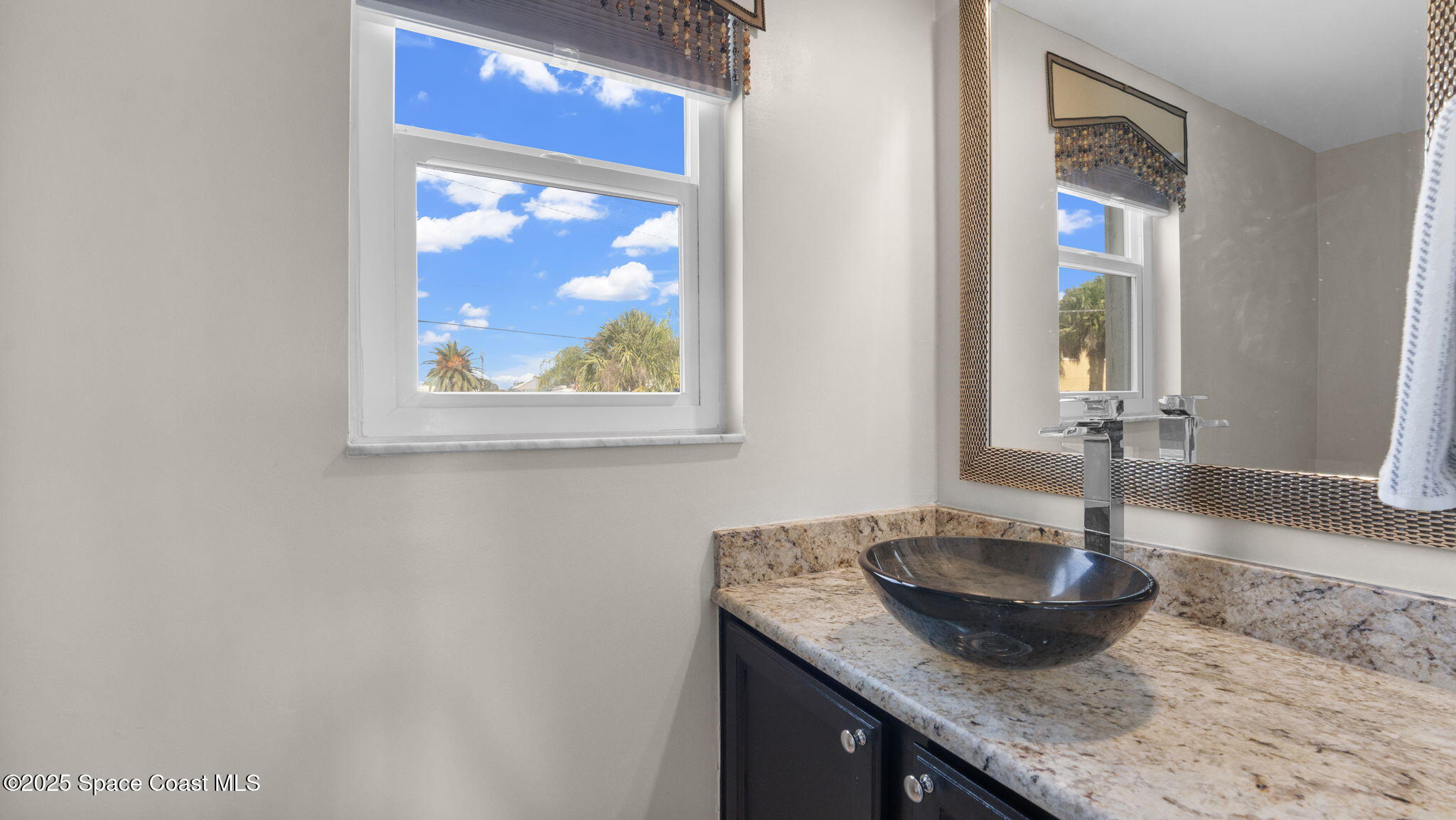 5087 Riveredge Drive, Unit 2 Titusville, FL 32780 - Photo 24 of 62 a bathroom with a granite countertop sink and a mirror