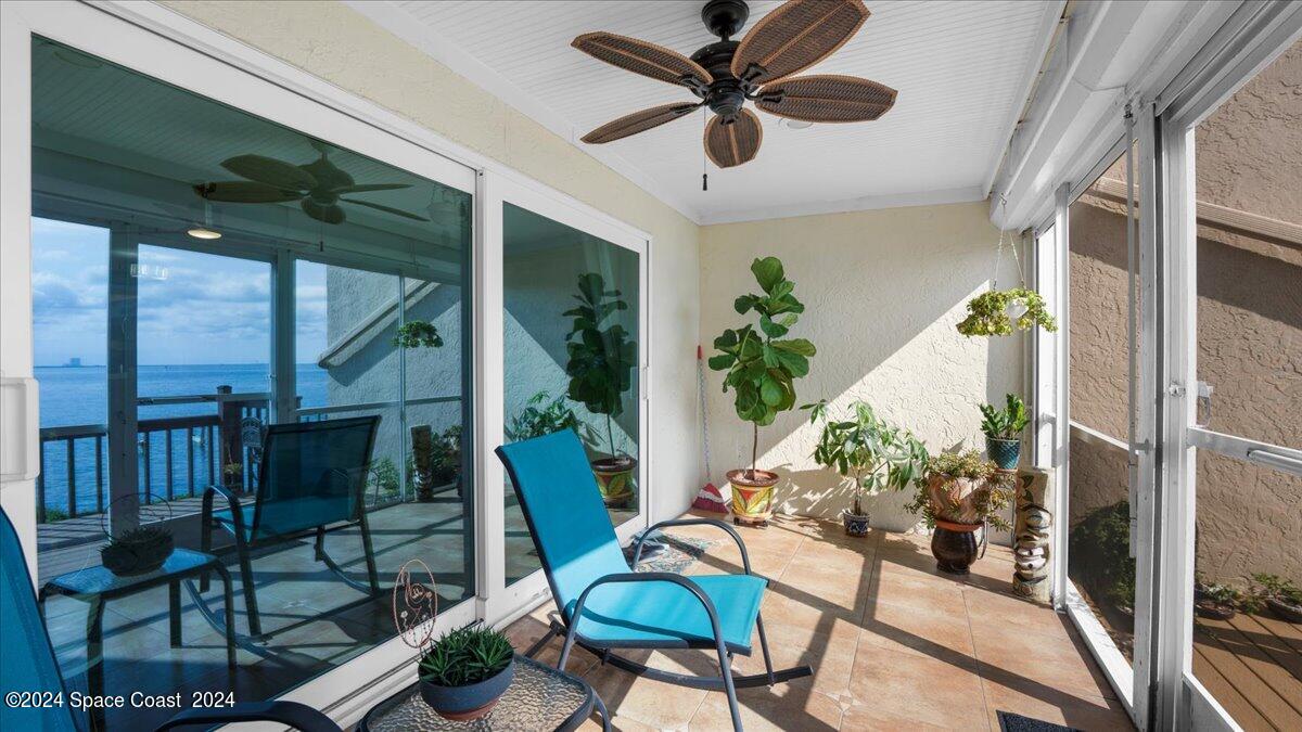 5087 Riveredge Drive, Unit 2 Titusville, FL 32780 - Photo 27 of 62 a view of a porch with furniture and a potted plant