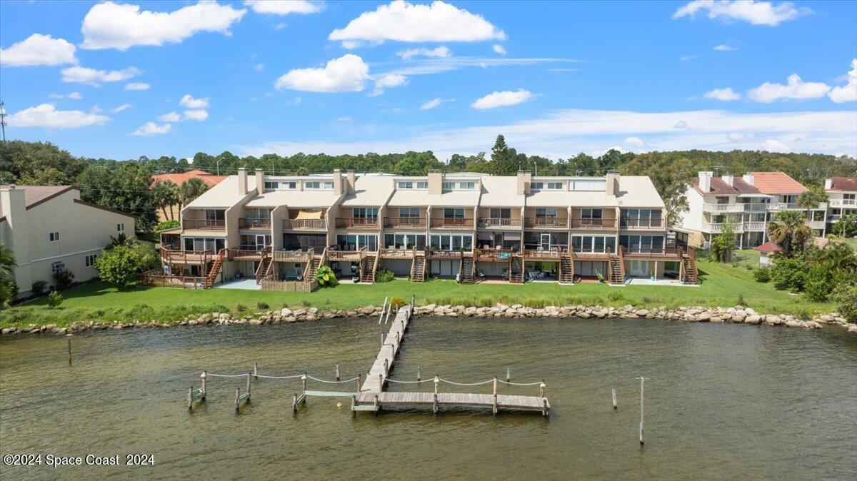5087 Riveredge Drive, Unit 2 Titusville, FL 32780 - Photo 42 of 62 a view of a lake with a city