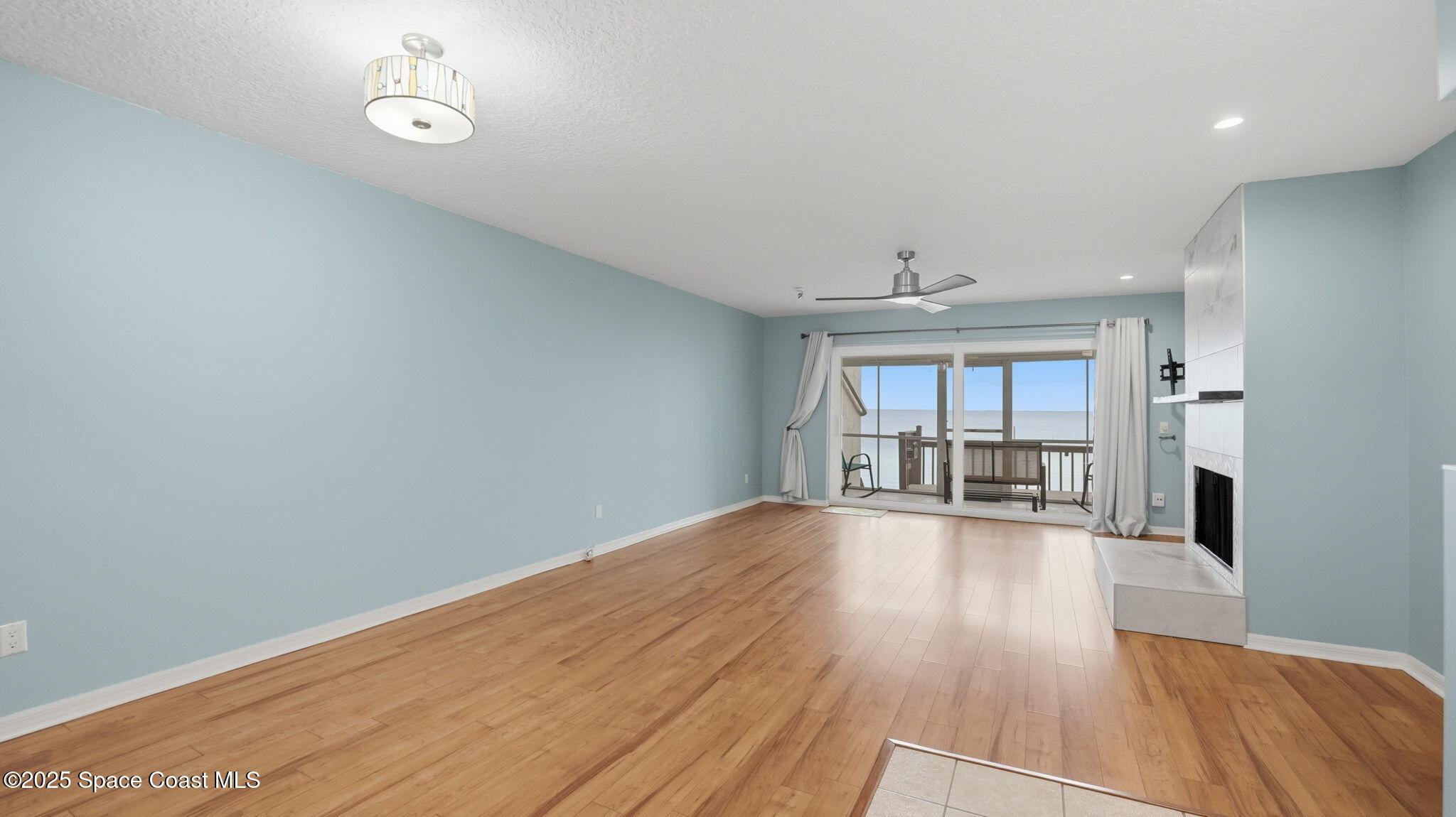 5087 Riveredge Drive, Unit 2 Titusville, FL 32780 - Photo 8 of 62 a view of empty room with wooden floor and fan